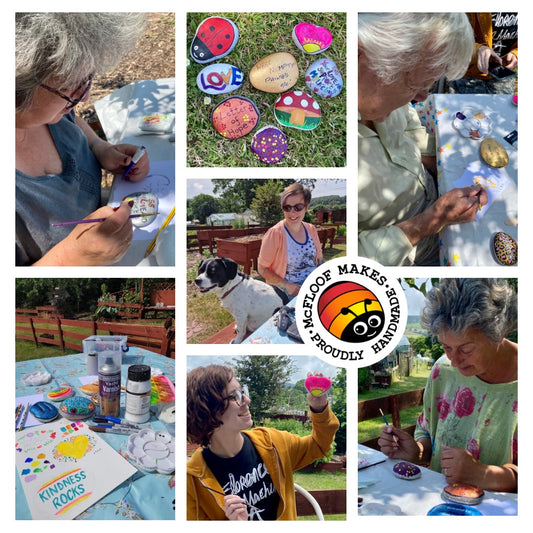 Photo of a rock painting workshop with people sat around a table