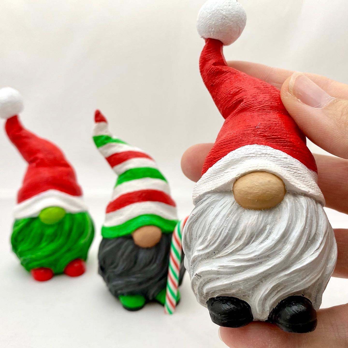 A trio of festive handpainted gonk statues