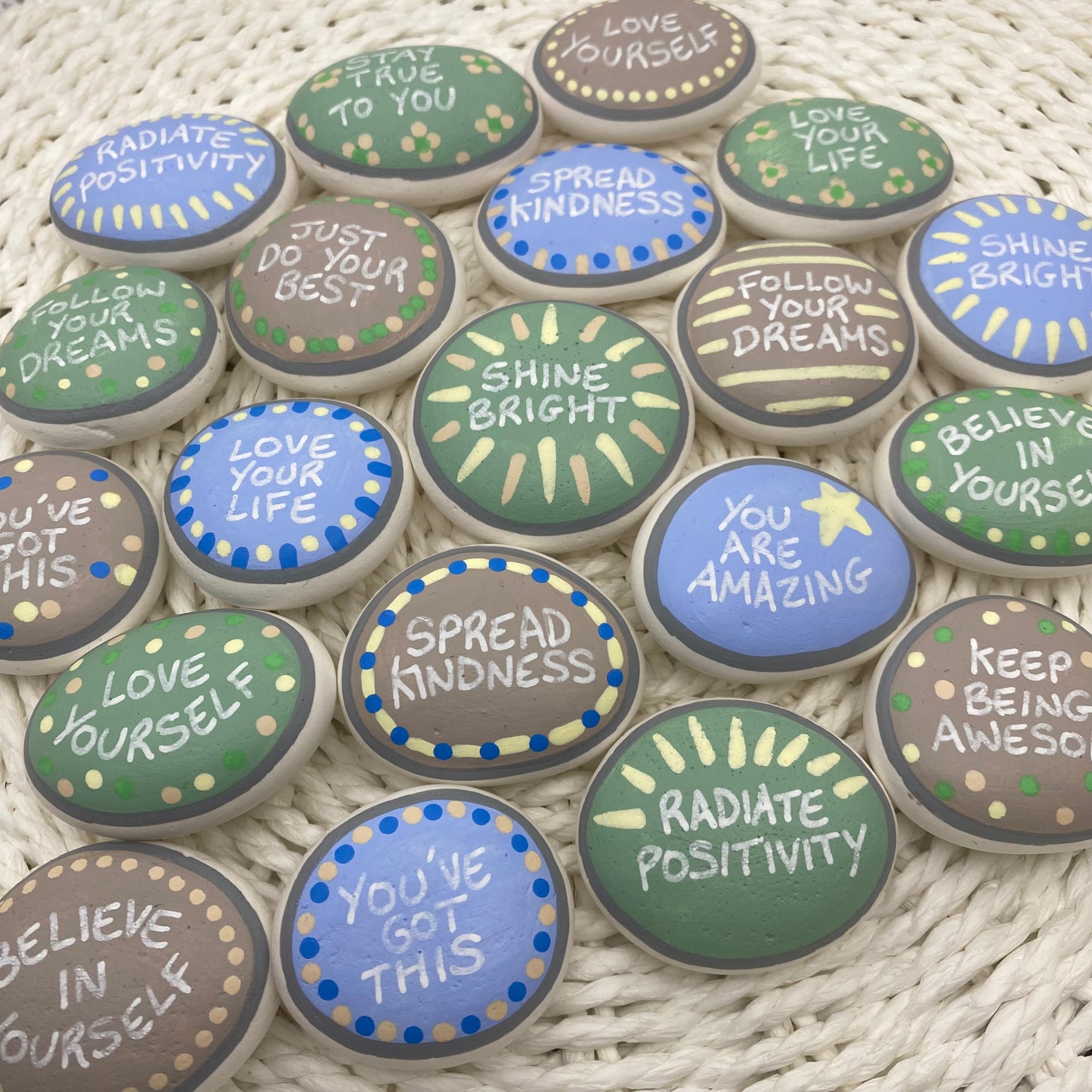 Lots of Pastel Blue, Green and Beige Hand painted pebbles with uplifting affirmations written on