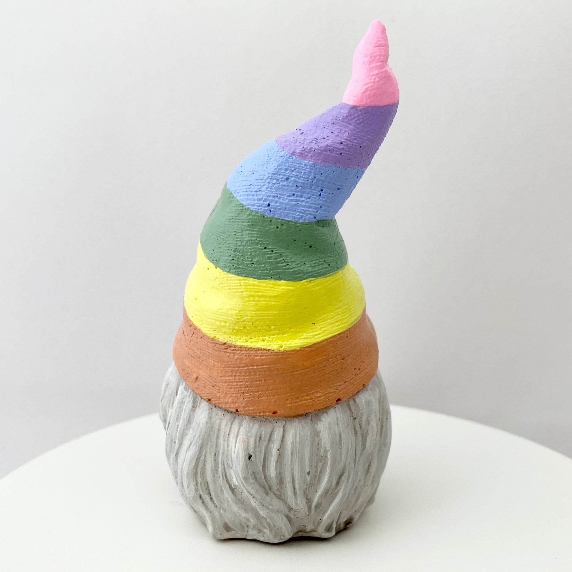 Hand painted Gonk statue with pastel rainbow striped hat