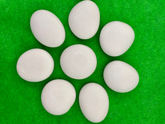 8 small white plaster pebbles of different shapes and sizes