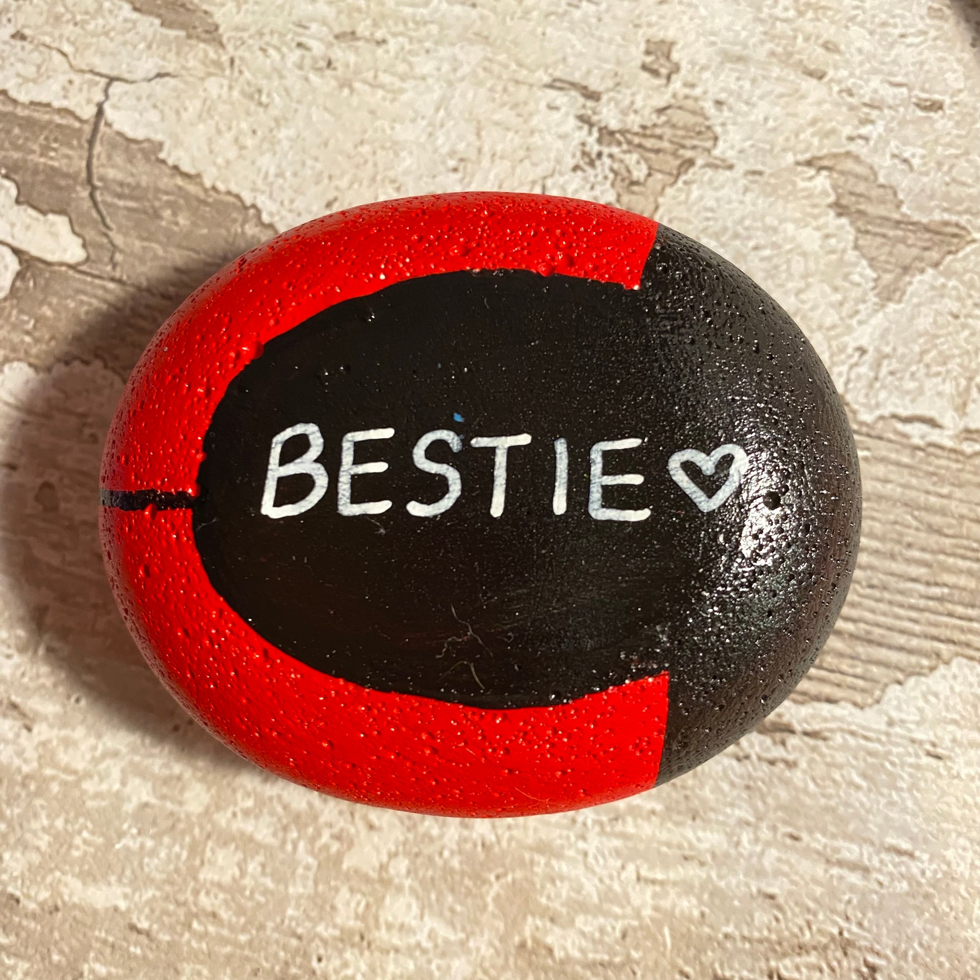 Hand painted Ladybug Pebble showing Underside Personalised with the word Bestie