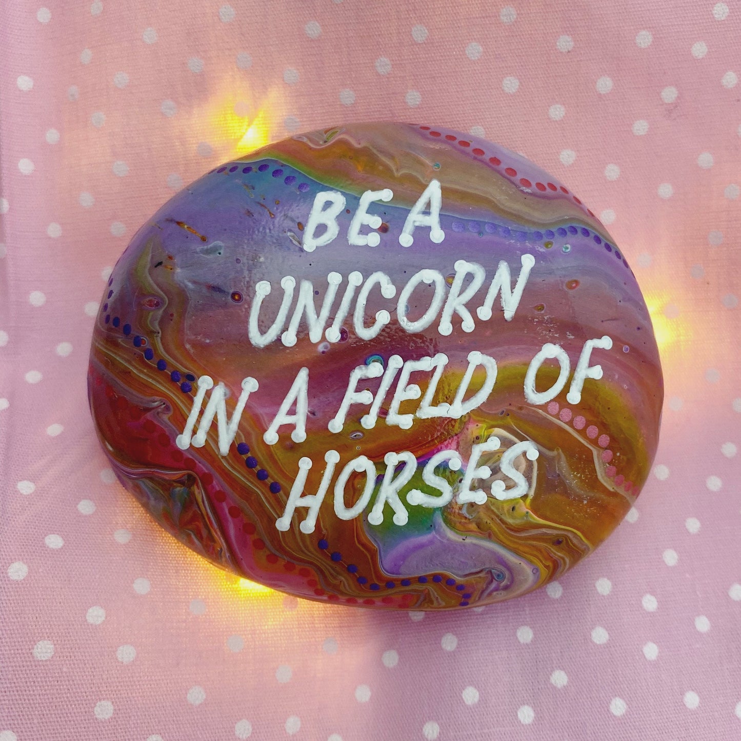 Colourful Hand painted Stone with the words Be A Unicorn in a Field of Horses