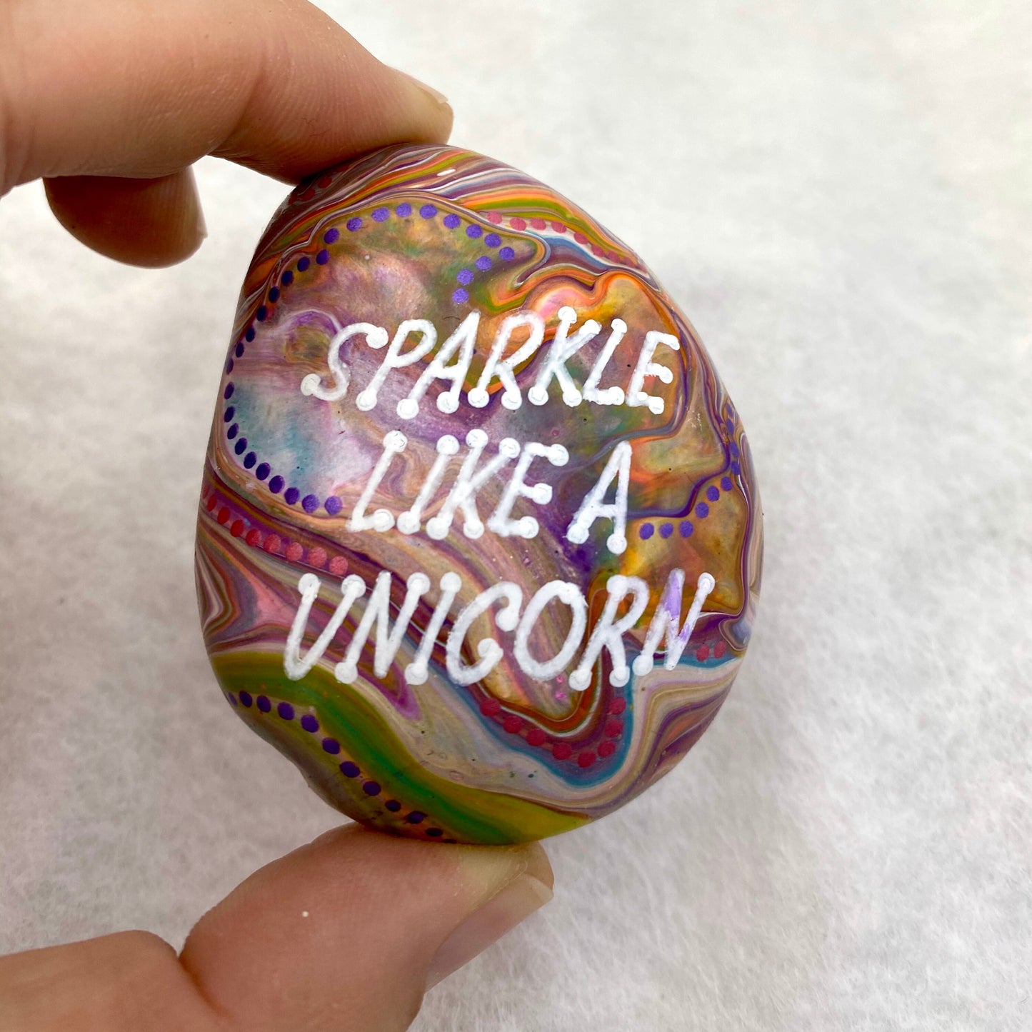 Colourful Hand painted Stone with the words Sparkle Like a Unicorn