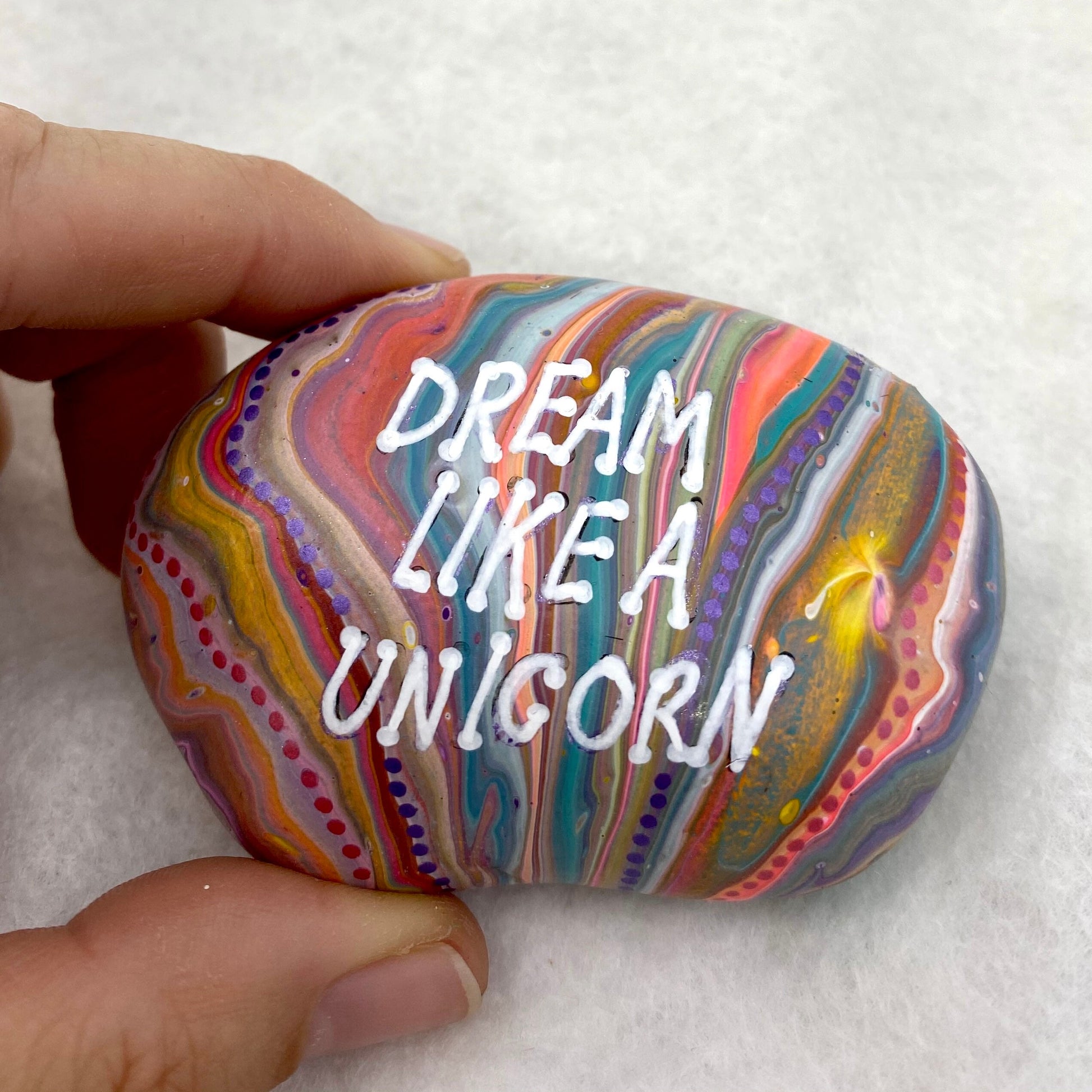 Colourful Hand painted Stone with the words Dream Like a Unicorn