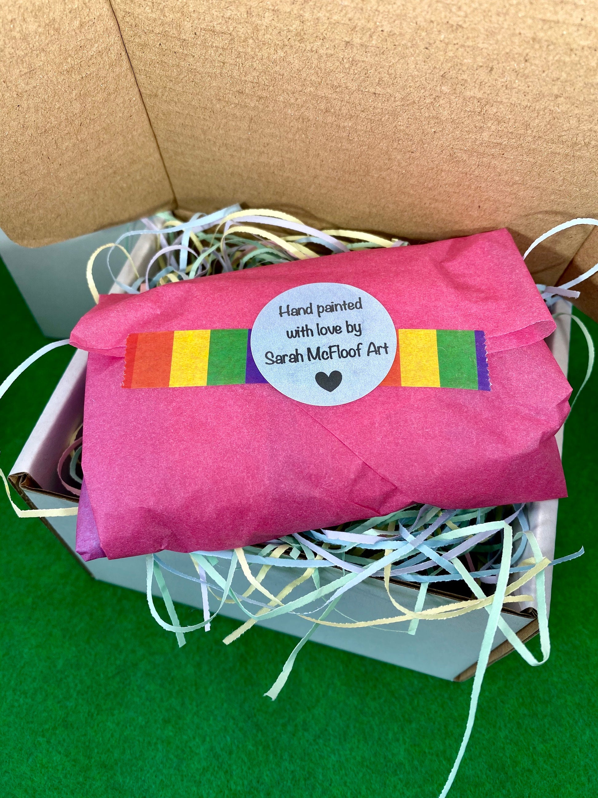 Paperweight stone wrapped in pink tissue paper